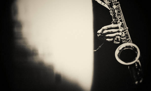 The saxophone player at the jazzclub Saxophone, Player, vintage, dark, art, jazz performance group photos stock pictures, royalty-free photos & images