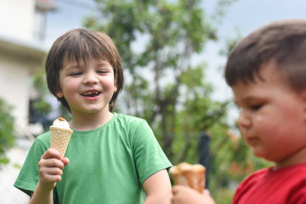 istock Happy little boy eating ice cream 1163212099