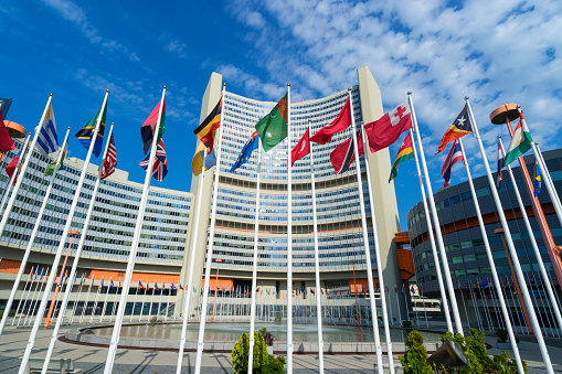 Vienna International Centre with waving flags in the foreground