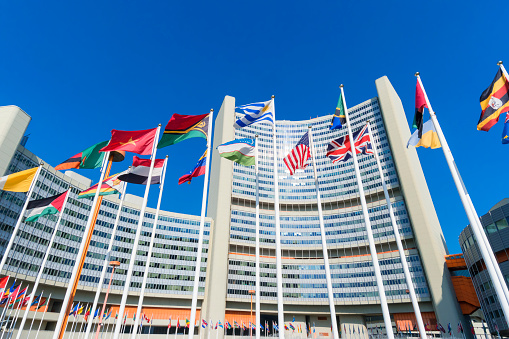 Vienna International Centre with waving flags in the foreground