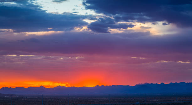 Panorama of colorful clouds at sunset Panorama of colorful clouds at sunset over an urban environment with mountains in the distance sunset cloudscape cloud arizona stock pictures, royalty-free photos & images