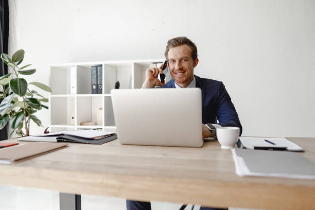 istock Contented entrepreneur with smartphone in his hand 1163217391
