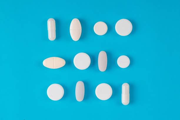 istock Assorted pharmaceutical medicine pills, tablets and capsules over blue background 1163217457