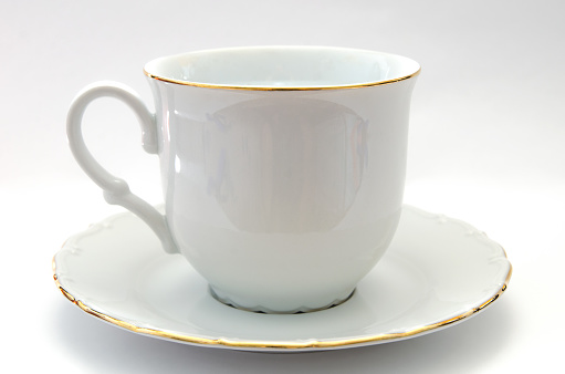 Cups and saucers standing one after another on a white background