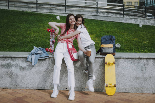 istock Two pretty female skater having coffee break 1163221075
