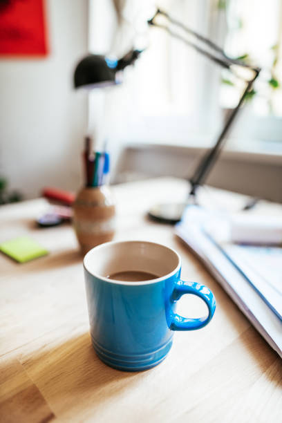 istock Coffee cup in blue cup on the desk 1163221083