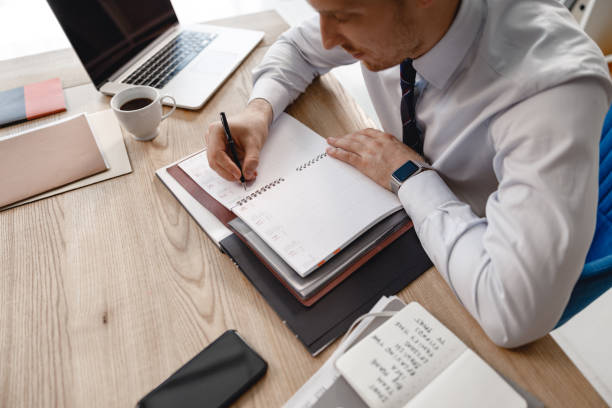 istock Daily planner on the table in front of office worker 1163222216
