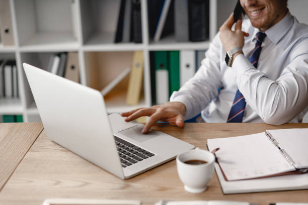 istock Man using touch pad of his laptop and smiling 1163222244