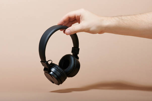 istock Hand hold black headphones 1163224972