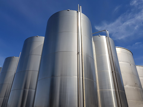 Steel clear tanks in the open air lined up in diamond shape dominate the camera