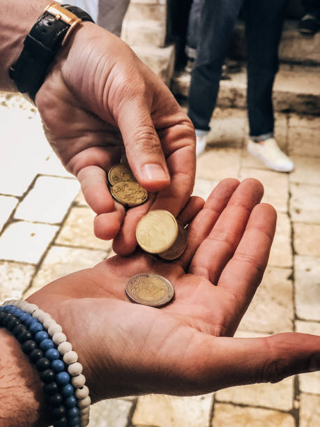 istock Hands holding euro coins 1163226483