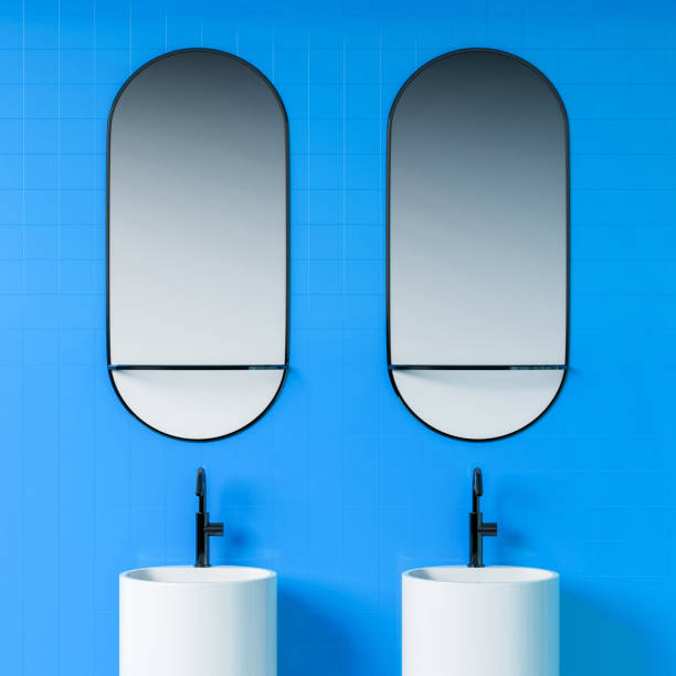 istock Close up of double sink in blue bathroom 1163227320