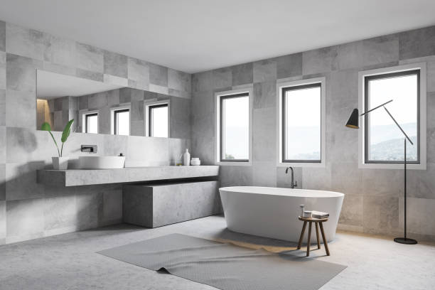 istock Gray tile bathroom corner, tub and sink 1163227410