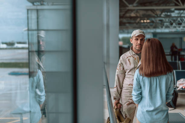 istock American sad soldier looking at woman while standing indoors 1163228106