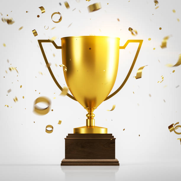 istock Golden champion trophy and confetti on white 1163228414