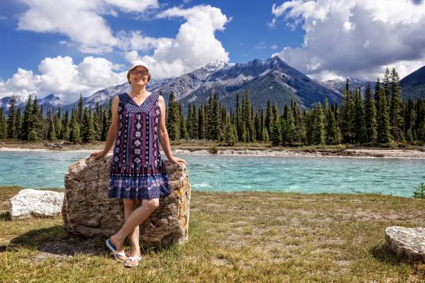 istock caucasian woman posing by  lake and mountains while on vacation 1163229139
