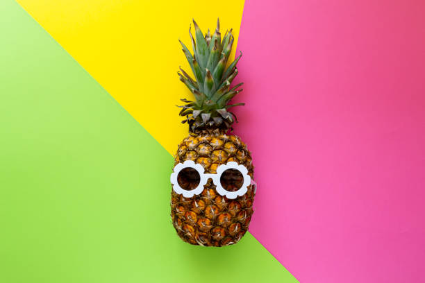 istock Pineapple in White Sunglasses on the Colorful Background, Creative Summer Concept 1163229505
