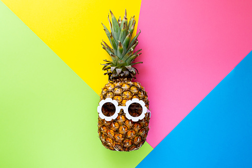 Pineapple in White Sunglasses on the Colorful Background, Creative Summer Concept