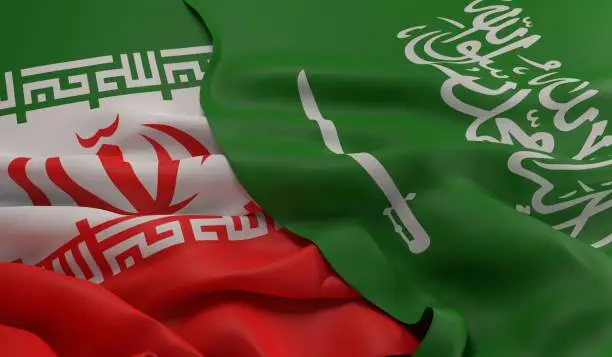 Flag of Saudi Arabia laying over the Iranian flag