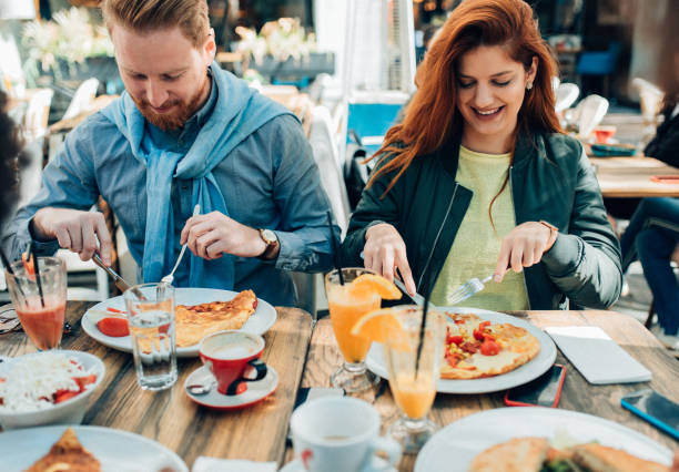 istock Young couple eating  outdoor 1163239178