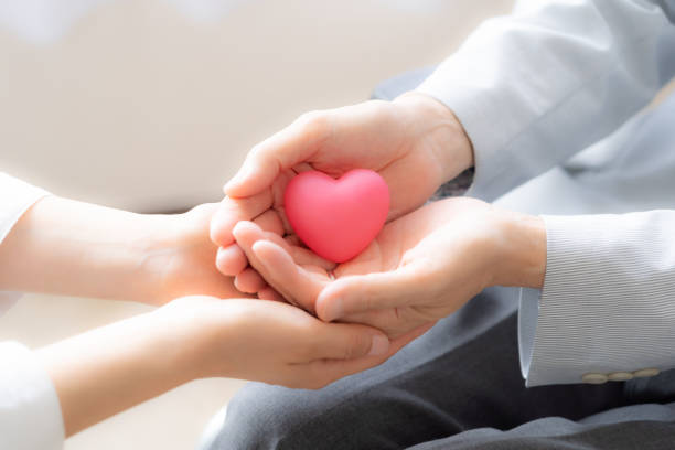 istock people holding heart symbol 1163241967