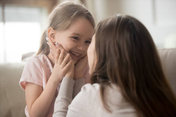 istock Young mom and smiling little daughter have fun playing 1163242803