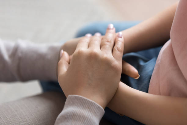 istock Loving mom hold little child hands showing support and care 1163242804