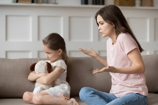istock Young mom talk making peace with offended little daughter 1163242819