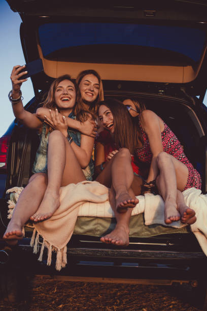 istock Friends having a laugh while taking a selfie with mobile phone together 1163242973