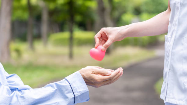 istock people holding heart symbol in park 1163243482