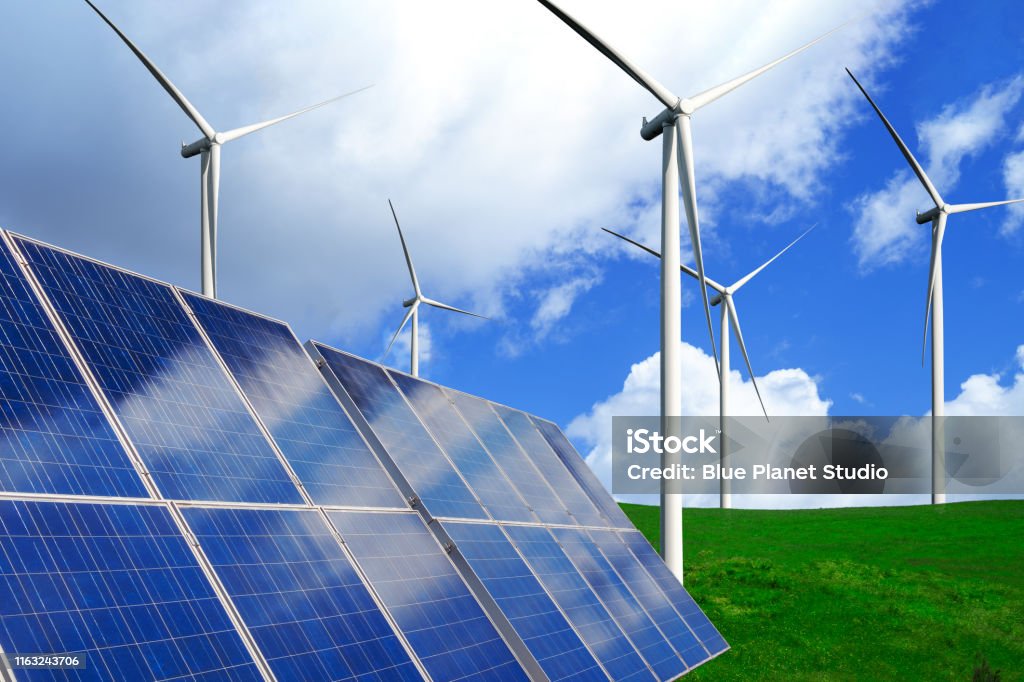 Solar panel and wind turbine farm clean energy. Solar energy panel photovoltaic cell and wind turbine farm power generator in nature landscape for production of renewable green energy is friendly industry. Clean sustainable development concept. Renewable Energy Stock Photo