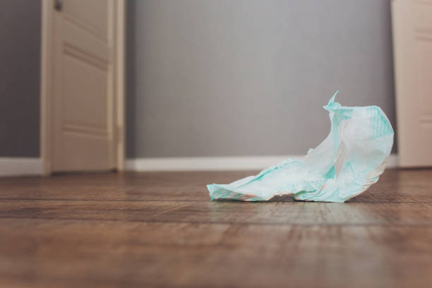 istock Changing babies diapers some used on the floor. 1163243758