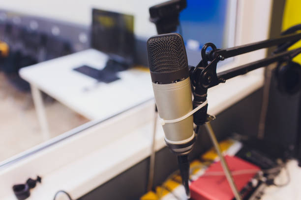 istock Recording equipment in studio. Studio microphone with headphones and mixer background. Elevated view. 1163243774