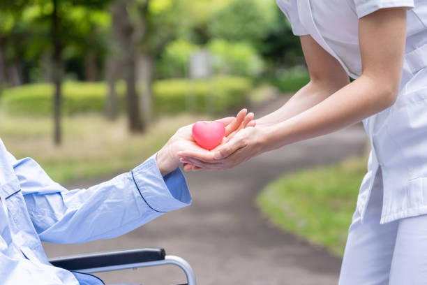 istock people holding heart symbol in park 1163243856