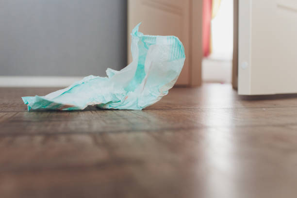 istock Changing babies diapers some used on the floor. 1163243941