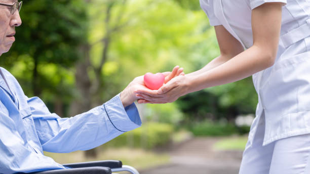 istock people holding heart symbol in park 1163244033