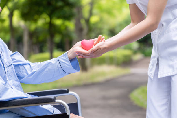 istock people holding heart symbol in park 1163244205