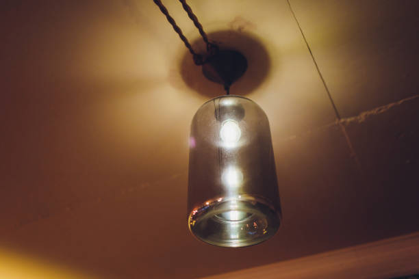 istock Standing brass chandelier with burning candles in shallow focus home setting. 1163244282