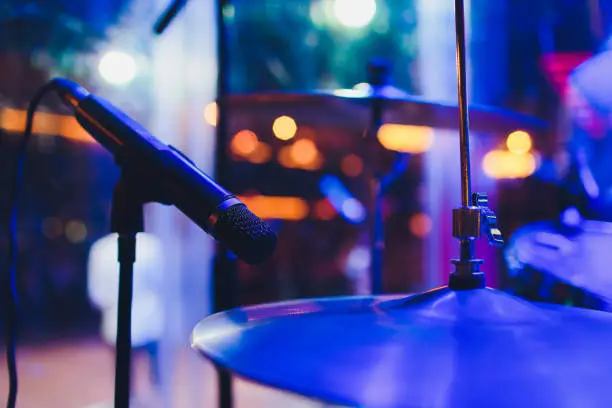 Photo of Drum kit on stage in the spotlight color.