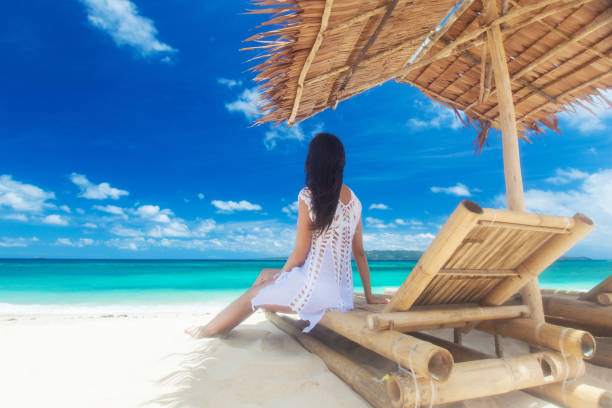 istock Woman sitting at chaise lounge 1163246310