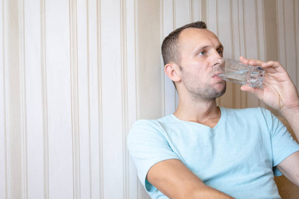 istock the guy is drinking clean glass water 1163249583