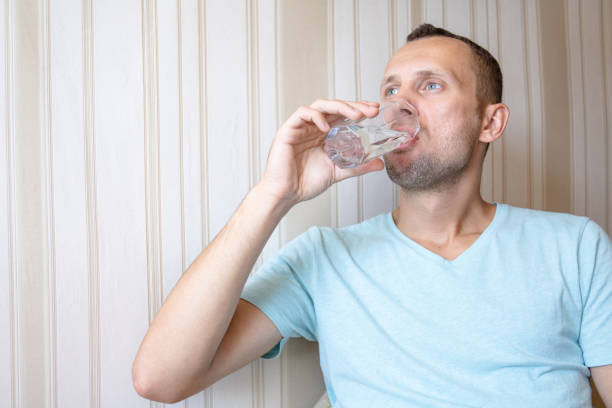 istock the guy is drinking clean glass water 1163249697