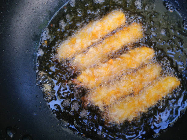 istock Fried shrimp in hot oil in a pan. Deep fried prawn in pans. 1163253185