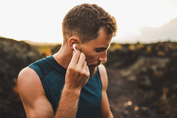 istock Man using wireless earphones air pods on running outdoors. Active lifestyle concept. 1163253864