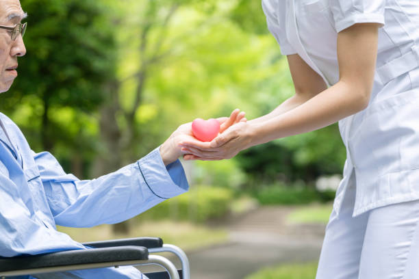 istock people holding heart symbol in park 1163255395