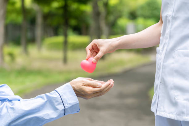 istock people holding heart symbol in park 1163255405