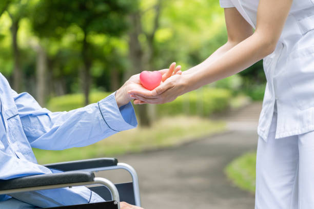 istock people holding heart symbol in park 1163255437