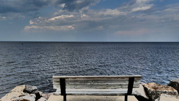 istock Wooden bench facing Lake St-Jean in Roberval 1163259816