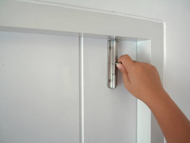 Woman hand lock the white door. Latch  the door for safety in life and property. Woman hand lock the white door. Latch  the door for safety in life and property. latch stock pictures, royalty-free photos & images