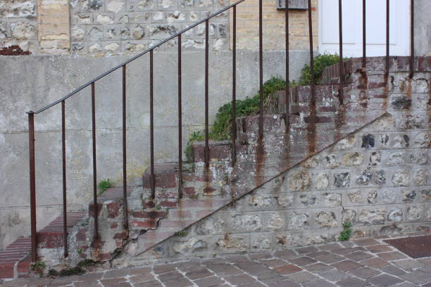 istock Old brick staircase on a stone wall  Rusty steel guardrail 1163260519